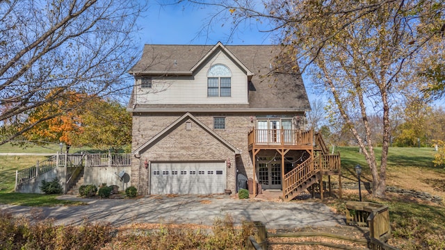 view of front facade featuring a wooden deck and a garage