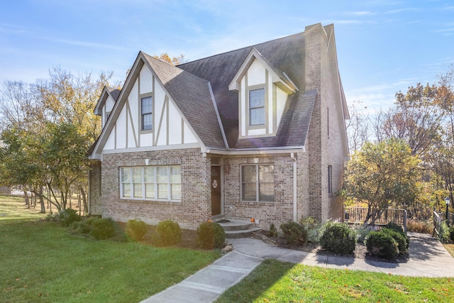 tudor home featuring a front lawn