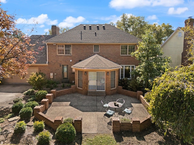 back of property featuring an outdoor fire pit and a patio