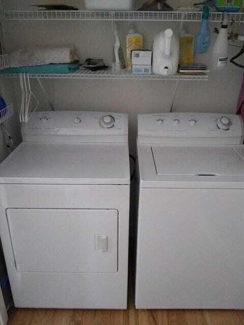 laundry area with hardwood / wood-style floors and washer and dryer