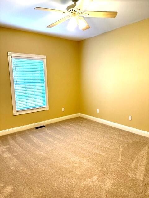 carpeted empty room with ceiling fan