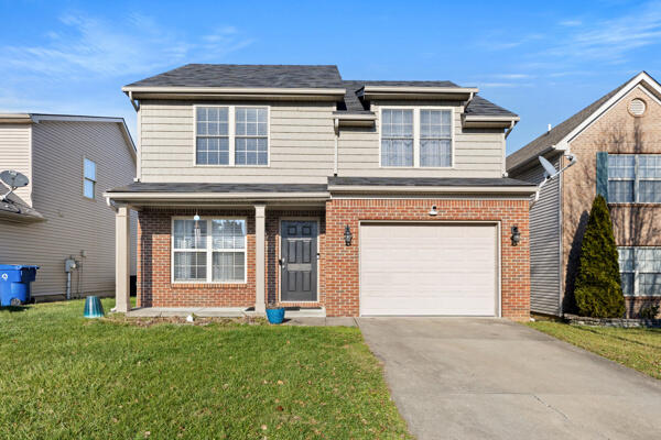 front facade with a front lawn and a garage