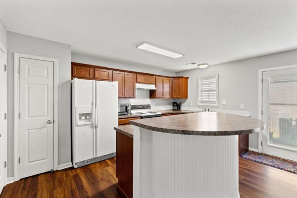 kitchen with stove, white fridge with ice dispenser, and dark wood-type flooring