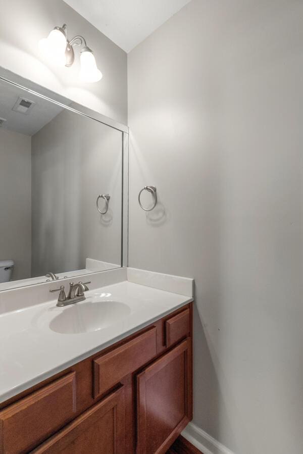 bathroom with vanity and toilet