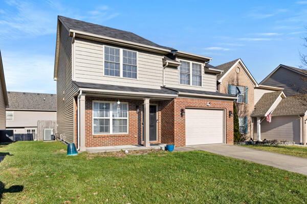 view of front property with a garage and a front lawn