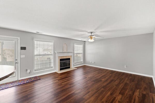 unfurnished living room with ceiling fan and dark hardwood / wood-style floors