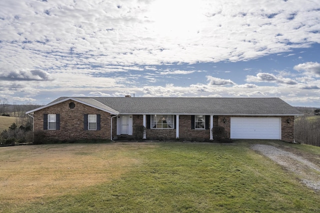 ranch-style home with a front yard and a garage