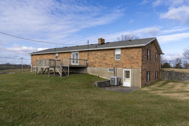 back of house with a lawn, a deck, and central AC