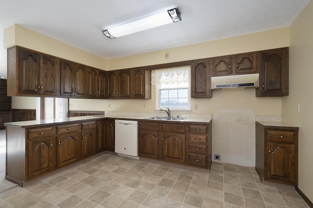 kitchen with dark brown cabinetry, sink, and white dishwasher