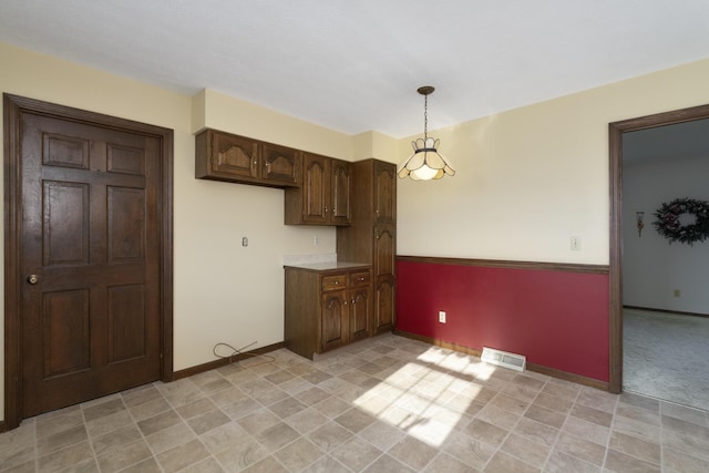 kitchen with pendant lighting and dark brown cabinetry