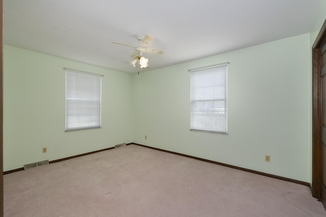 carpeted empty room featuring ceiling fan