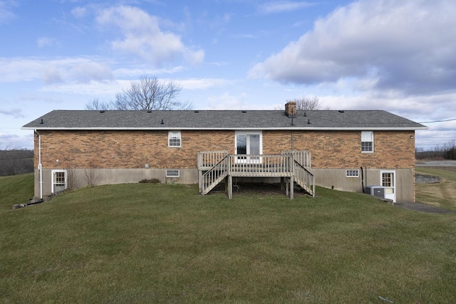 rear view of property with a wooden deck, a yard, and central AC