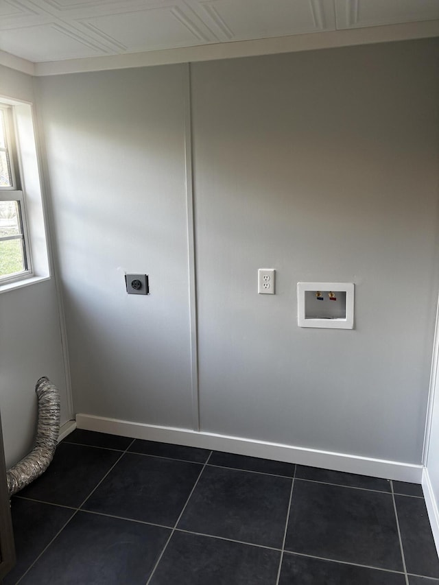 washroom featuring hookup for a washing machine, dark tile patterned flooring, and electric dryer hookup