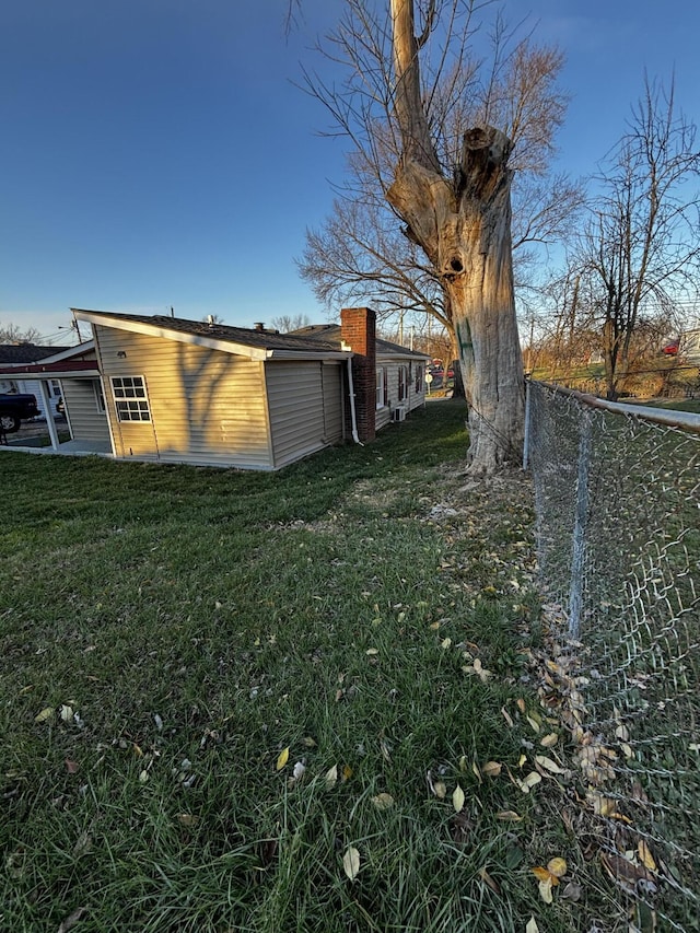 view of property exterior with a lawn