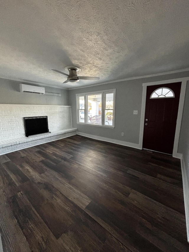 unfurnished living room featuring an AC wall unit, a brick fireplace, ceiling fan, a textured ceiling, and dark hardwood / wood-style flooring