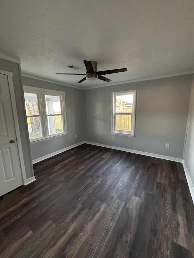 spare room with dark hardwood / wood-style floors, ceiling fan, and ornamental molding