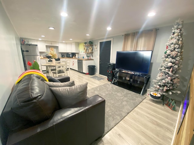 living room with sink and light hardwood / wood-style flooring