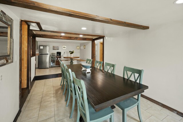 interior space featuring baseboards, a textured ceiling, and freestanding refrigerator