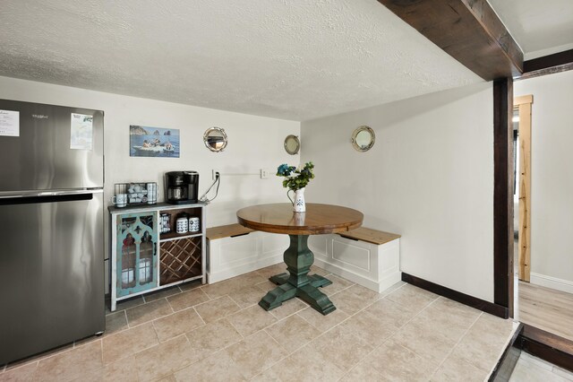 kitchen with white microwave, gray cabinetry, stainless steel dishwasher, a sink, and range with electric stovetop