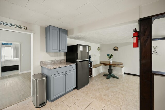 kitchen featuring beverage cooler, visible vents, dishwasher, white microwave, and gray cabinetry