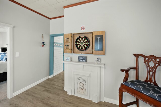 playroom with light wood finished floors, baseboards, pool table, and ornamental molding