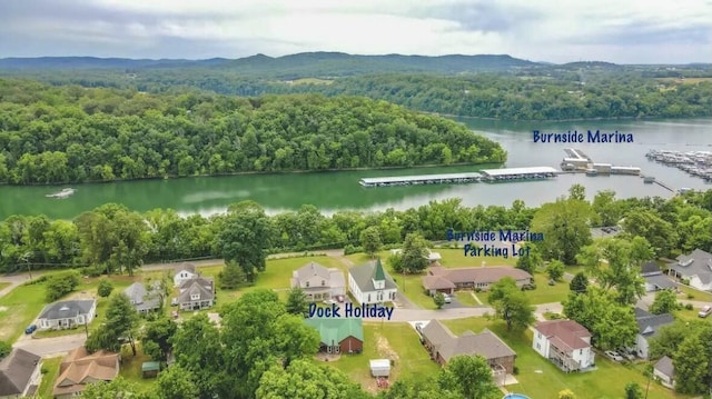 aerial view with a water view, a wooded view, and a residential view