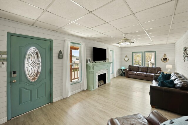 living room featuring a drop ceiling and wood finished floors