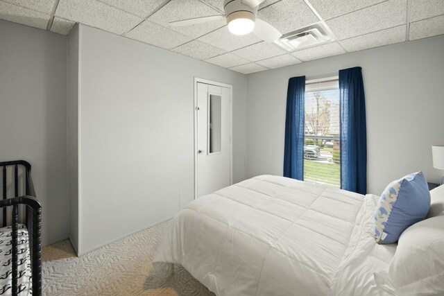 bedroom featuring a paneled ceiling and a ceiling fan