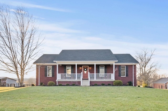 ranch-style home featuring a porch and a front lawn