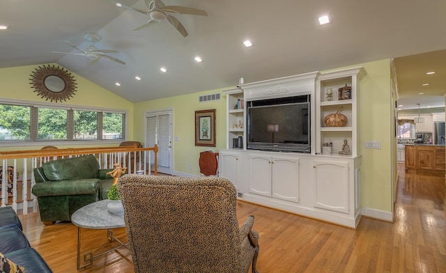 living room with light hardwood / wood-style floors and lofted ceiling