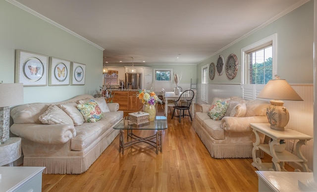 living room featuring light hardwood / wood-style floors and crown molding