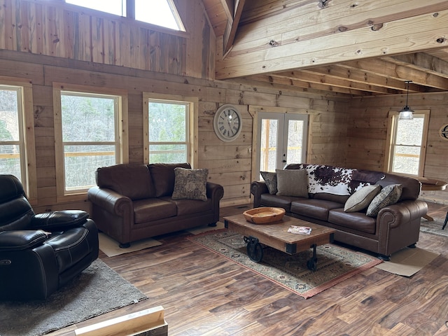 living room with wood walls, wood finished floors, and a wealth of natural light