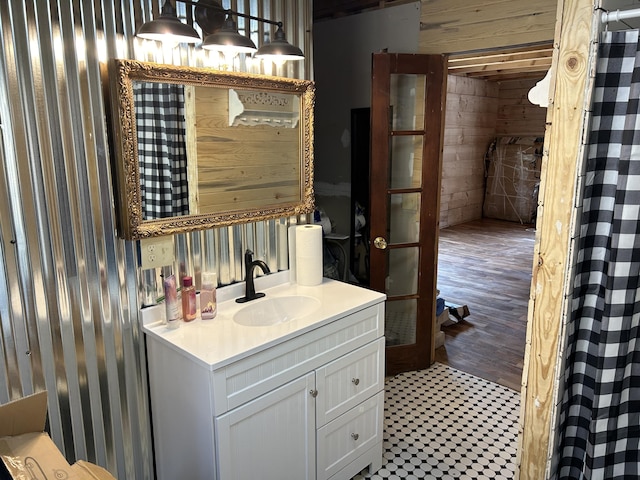 bathroom with wood walls and vanity