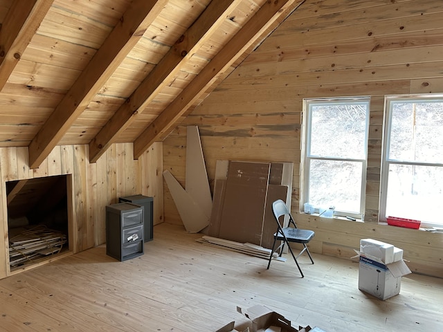 bonus room with light wood-style floors, wood ceiling, wooden walls, and lofted ceiling with beams