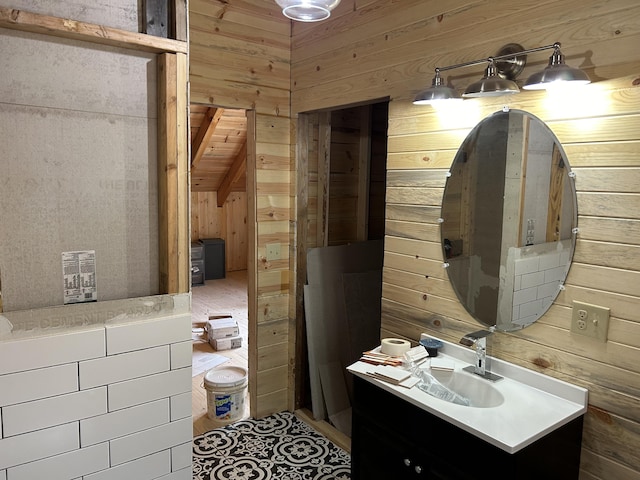 bathroom featuring wooden walls and vanity