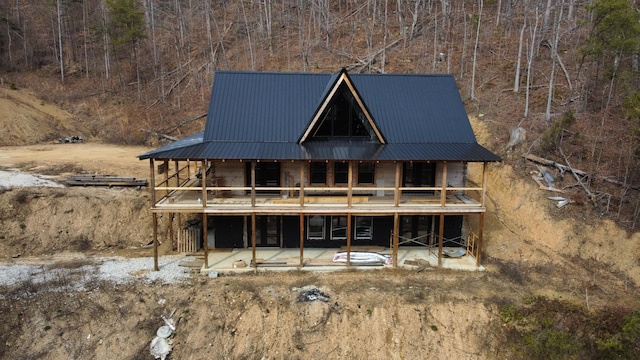 back of property with a patio area and metal roof