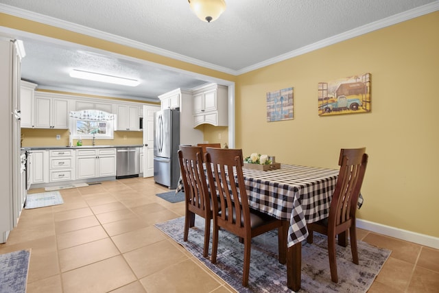 dining space with light tile patterned floors, a textured ceiling, baseboards, and ornamental molding