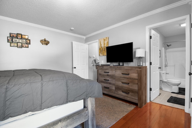 bedroom featuring a textured ceiling, wood finished floors, and ornamental molding