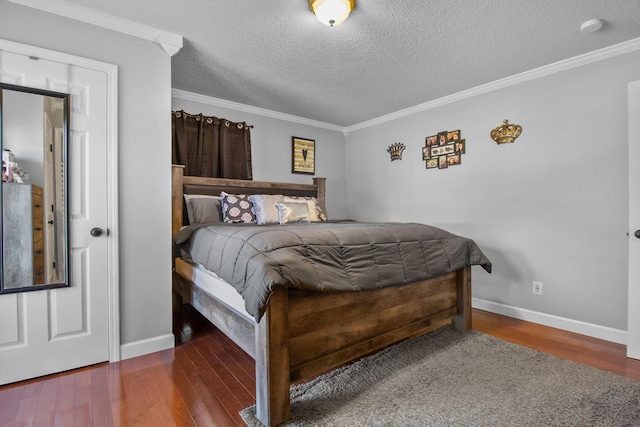 bedroom with a textured ceiling, wood finished floors, baseboards, and ornamental molding