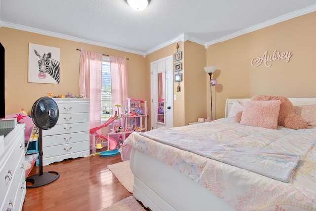 bedroom featuring a textured ceiling, crown molding, and wood finished floors