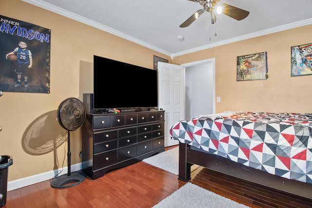 bedroom featuring ceiling fan, baseboards, wood finished floors, and crown molding