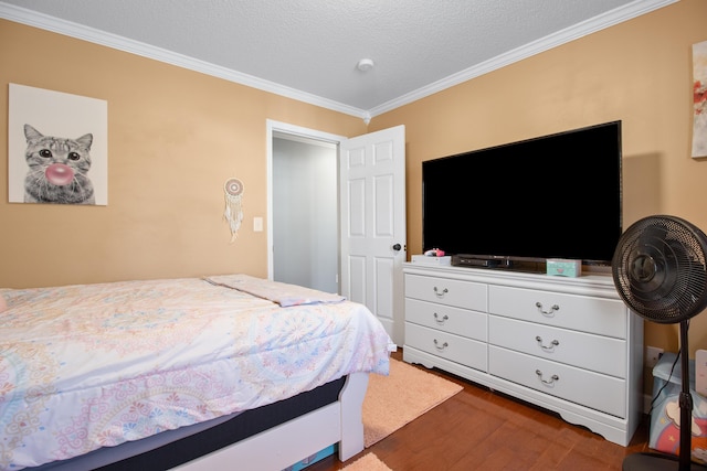 bedroom featuring dark wood-type flooring, crown molding, and a textured ceiling