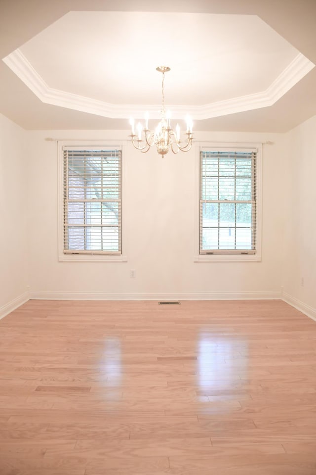 781 E Lexington St, Harrodsburg, KY 40330 - empty room with a chandelier, plenty of natural light, light wood-style flooring, and crown molding
