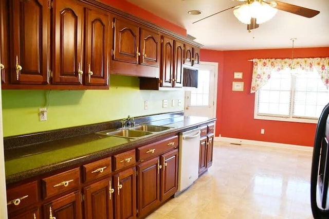 kitchen with dishwashing machine, pendant lighting, ceiling fan, and sink