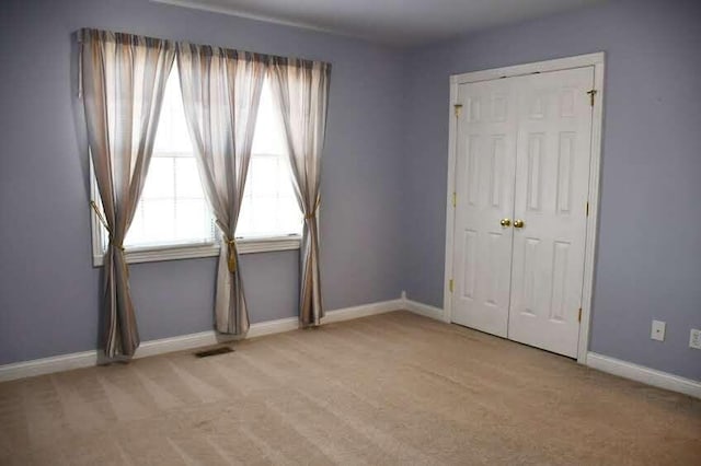 empty room with light colored carpet