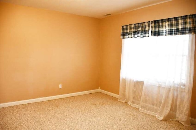 unfurnished room featuring carpet