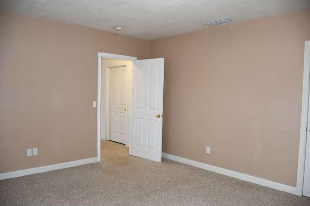 empty room with light colored carpet