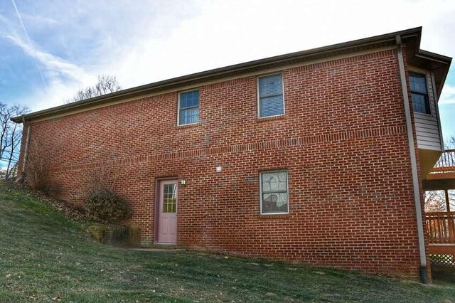 view of side of home featuring a lawn