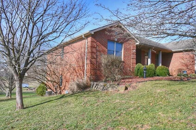 view of side of property with a lawn