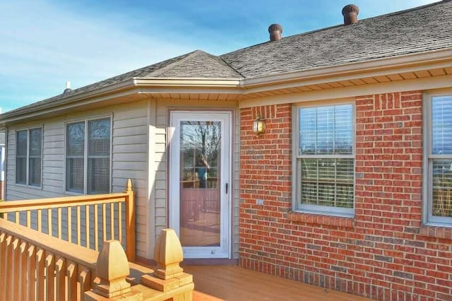 view of exterior entry featuring a deck